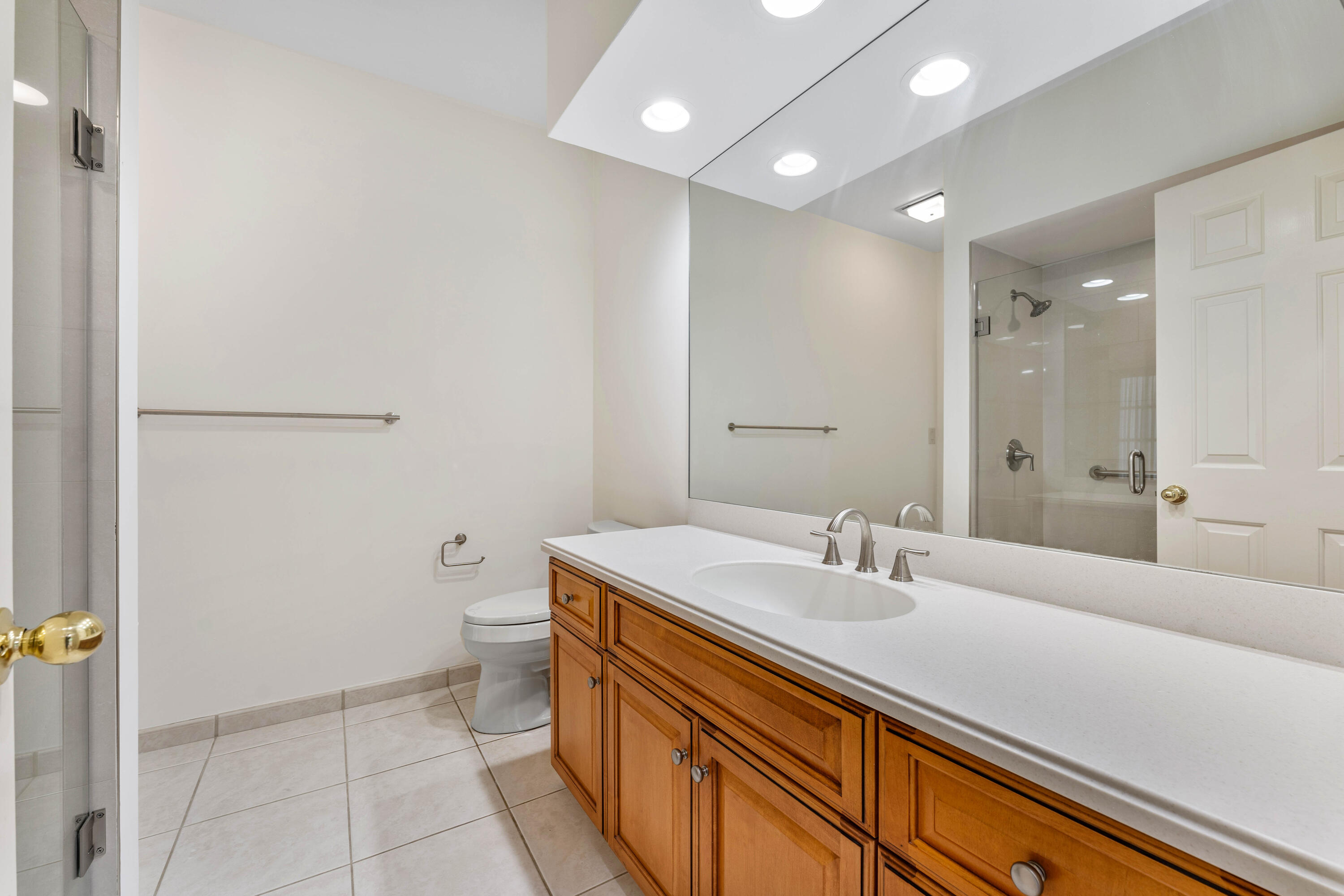 1851 Thatch Palm Drive Boca Raton, FL 33432 - Photo 42 of 70 a bathroom with a sink a toilet and a mirror