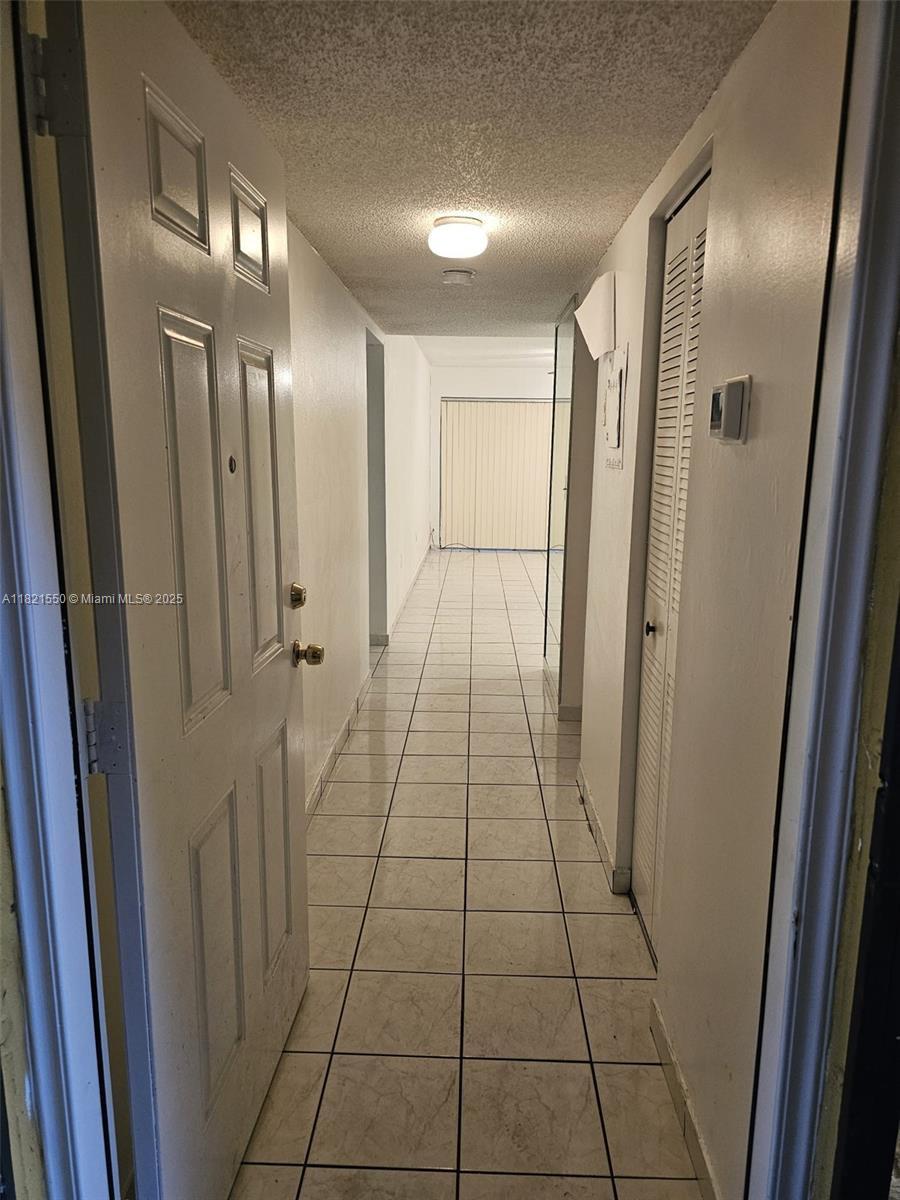 1555 West 44th Place, Unit 221B Hialeah, FL 33012 - Photo 3 of 15 a view of a hallway