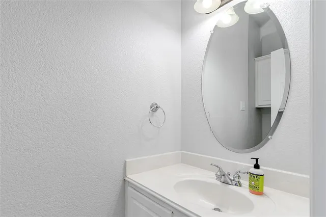 a bathroom with a sink vanity and a mirror