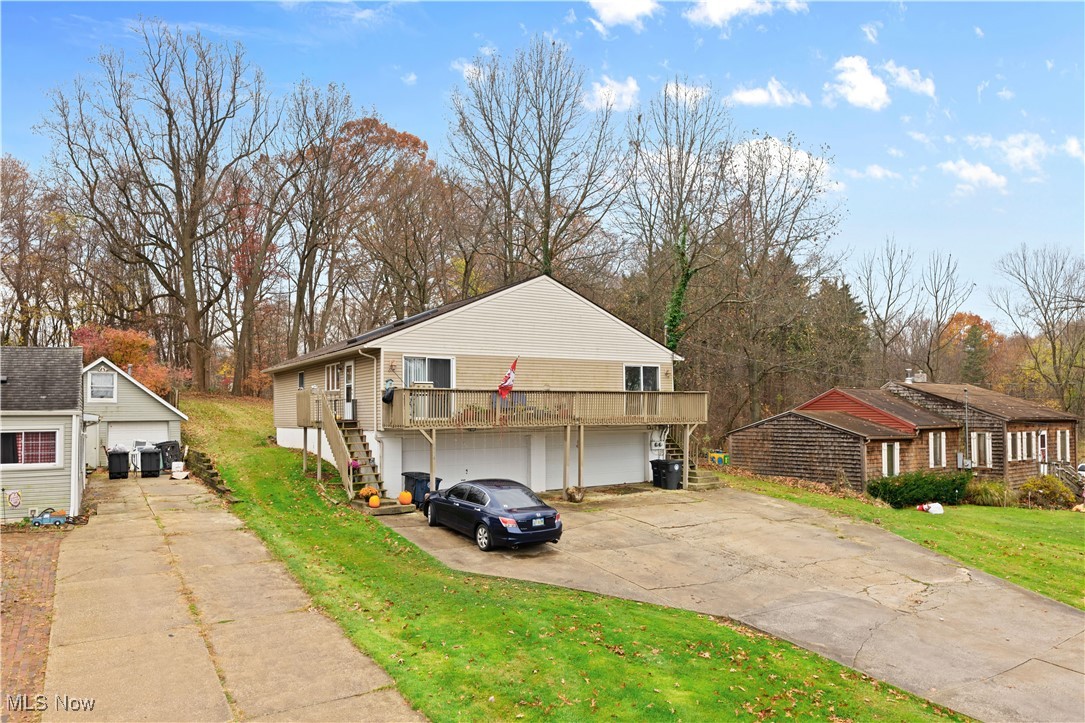1574 Faye Road Akron, OH 44306 - Photo 2 of 45 View of front of property featuring a front yard, a garage, and a deck