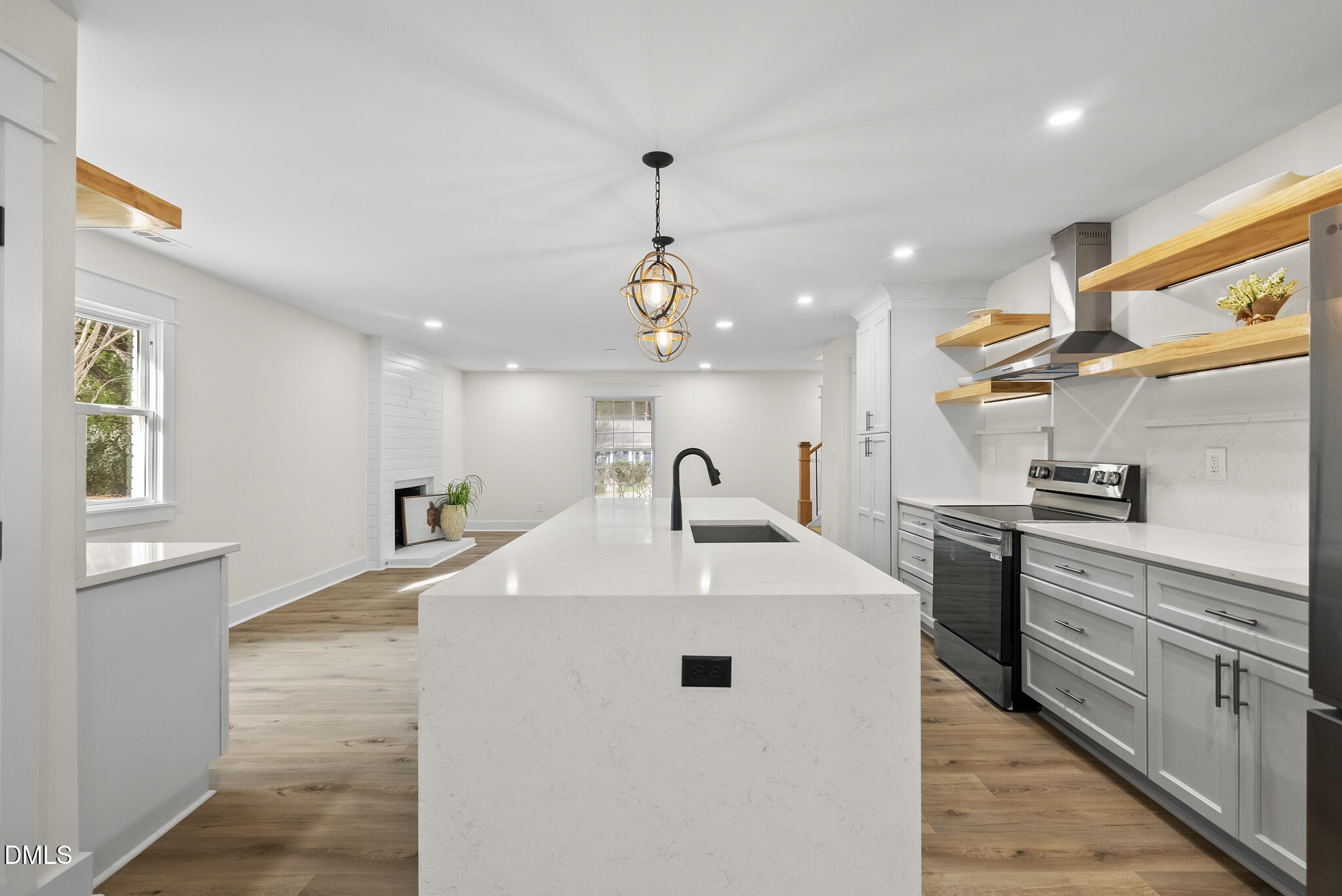 7804 Brandyapple Drive Raleigh, NC 27615 - Photo 15 of 58 a kitchen with stainless steel appliances kitchen island a sink a stove and a refrigerator
