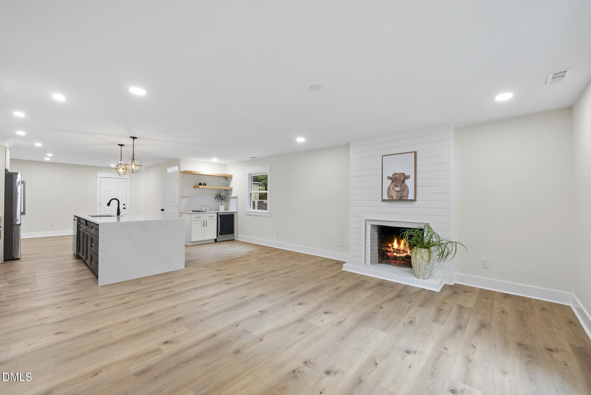 7804 Brandyapple Drive Raleigh, NC 27615 - Photo 17 of 58 a view of a kitchen with a sink and a fireplace
