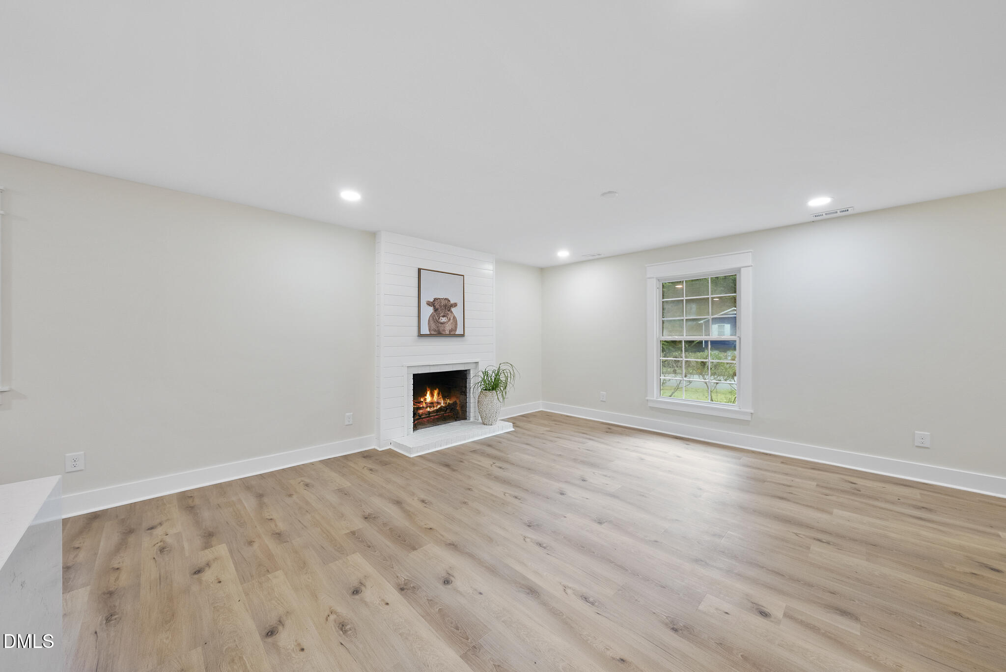 7804 Brandyapple Drive Raleigh, NC 27615 - Photo 20 of 58 a view of an empty room with wooden floor and a window