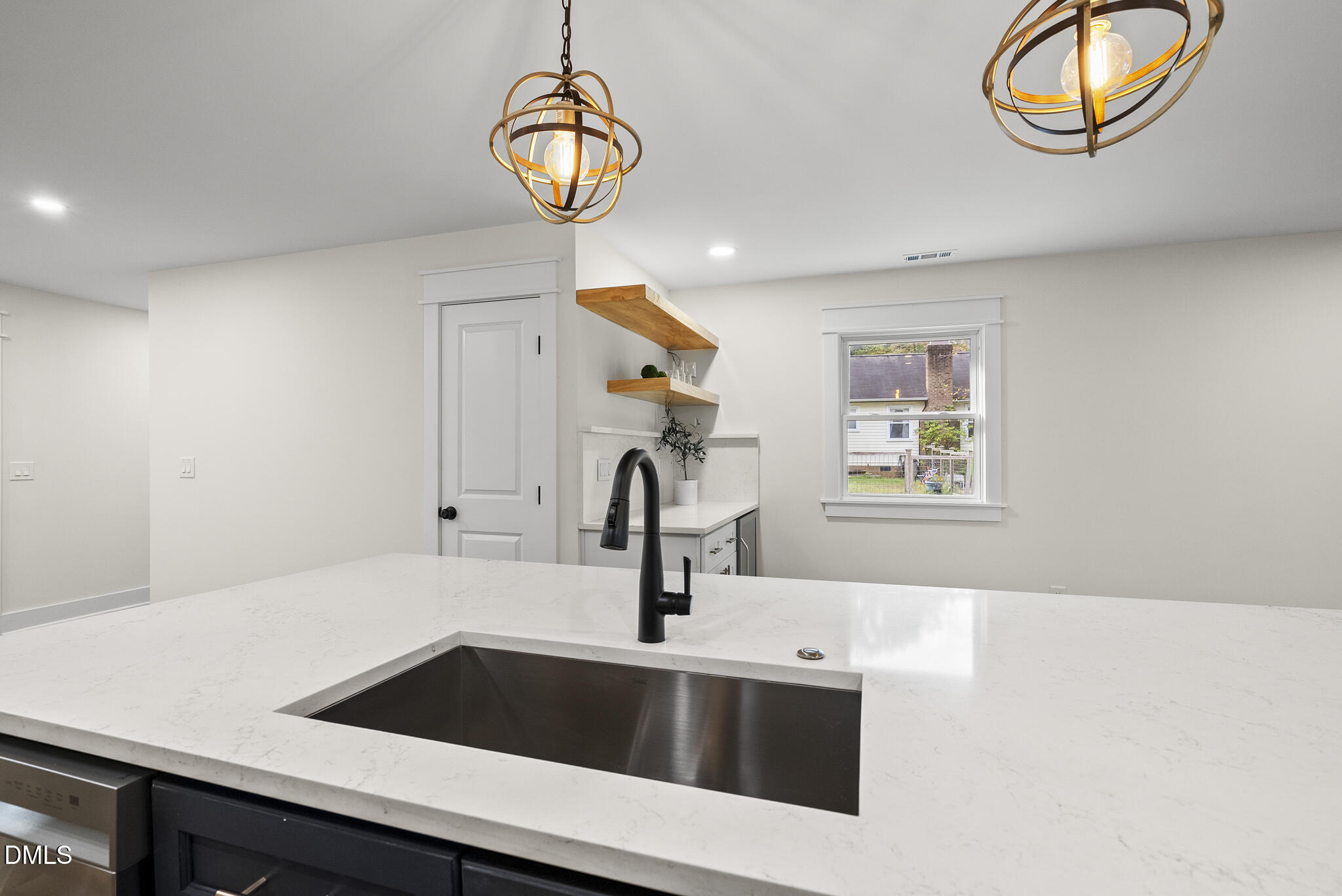 7804 Brandyapple Drive Raleigh, NC 27615 - Photo 21 of 58 a kitchen with a sink and a refrigerator