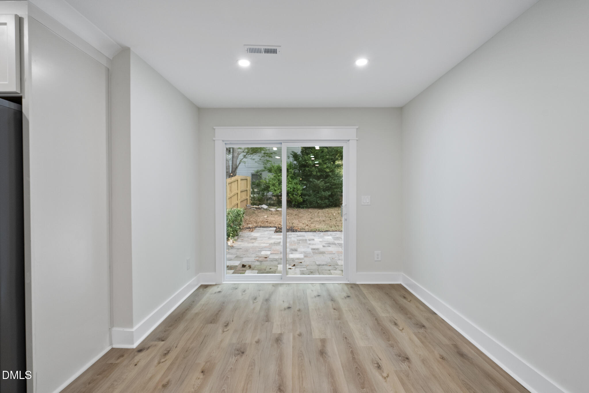 7804 Brandyapple Drive Raleigh, NC 27615 - Photo 24 of 58 a view of empty room with wooden floor and fan