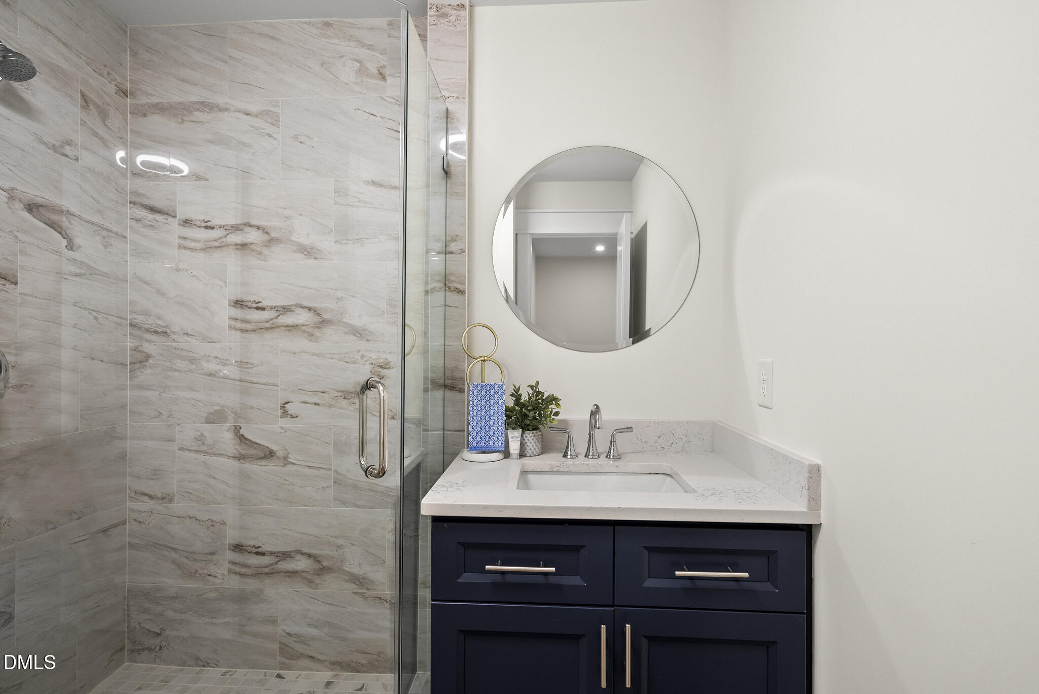 7804 Brandyapple Drive Raleigh, NC 27615 - Photo 27 of 58 a bathroom with a sink vanity and a mirror
