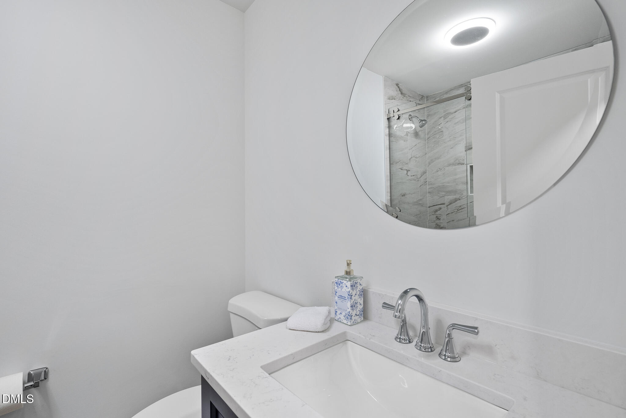 7804 Brandyapple Drive Raleigh, NC 27615 - Photo 30 of 58 a bathroom with a sink and a mirror