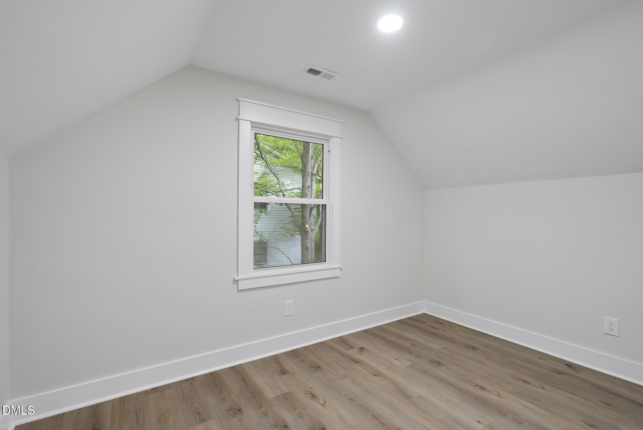 7804 Brandyapple Drive Raleigh, NC 27615 - Photo 38 of 58 an empty room with wooden floor and windows