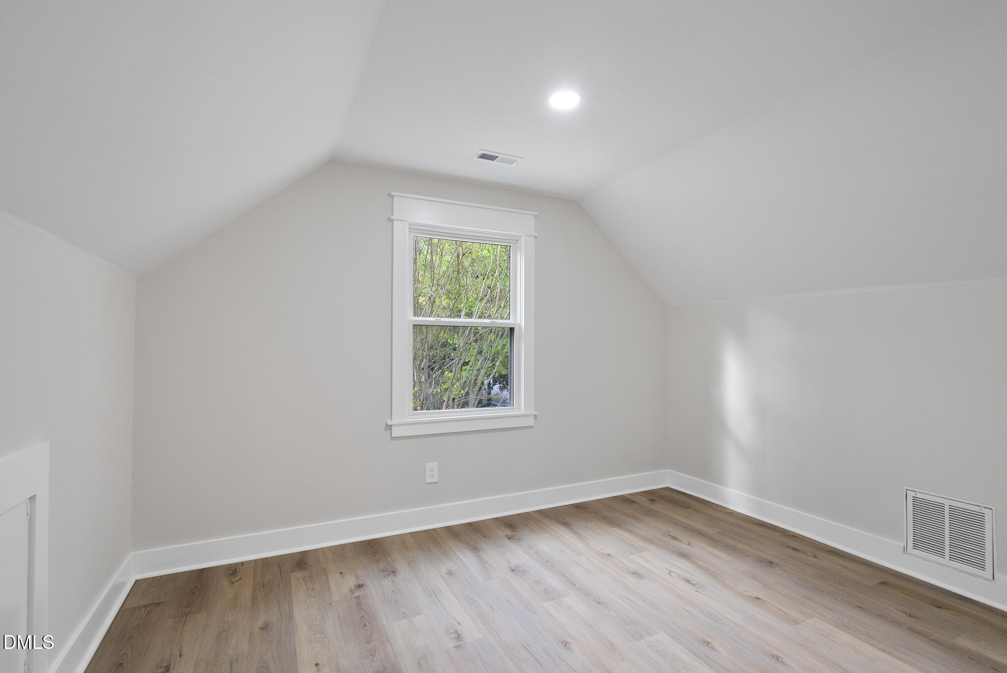 7804 Brandyapple Drive Raleigh, NC 27615 - Photo 39 of 58 an empty room with wooden floor and windows