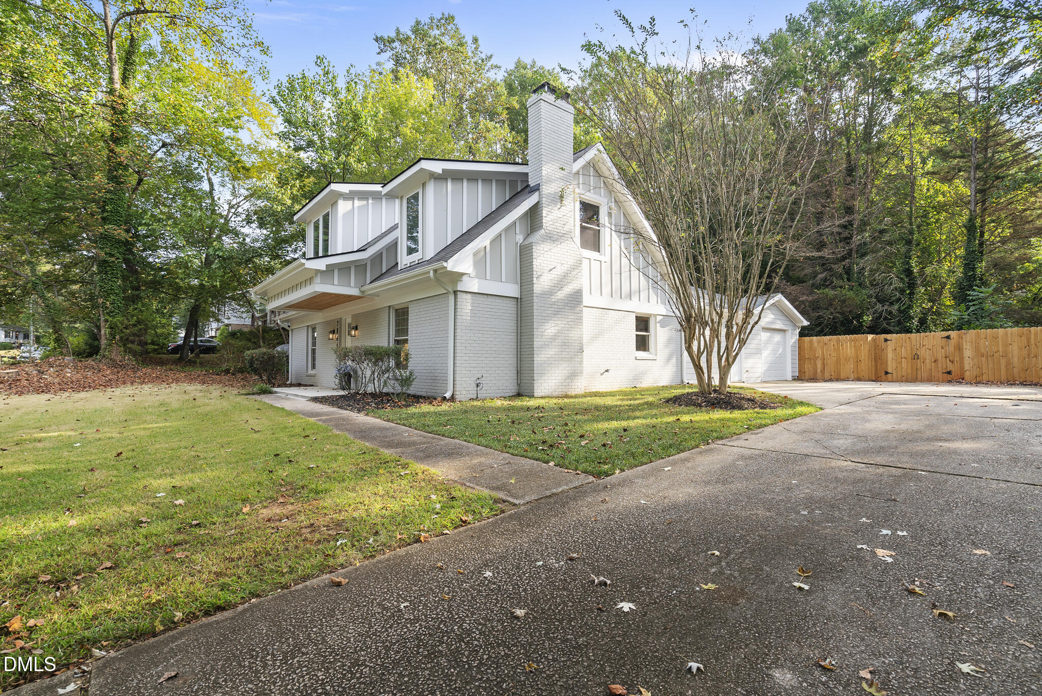 7804 Brandyapple Drive Raleigh, NC 27615 - Photo 5 of 58 a view of a big house with a big yard and large trees