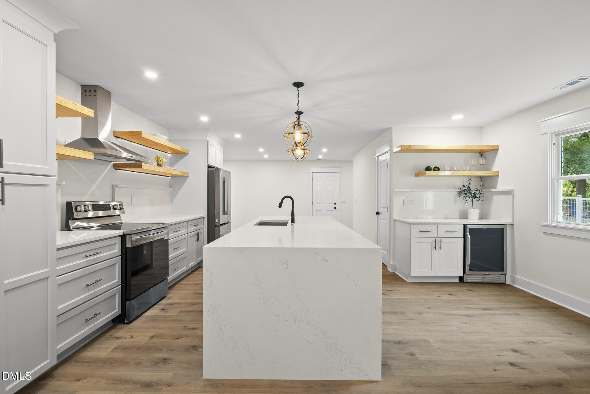 7804 Brandyapple Drive Raleigh, NC 27615 - Photo 8 of 58 a large kitchen with stainless steel appliances granite countertop a sink and stove top oven