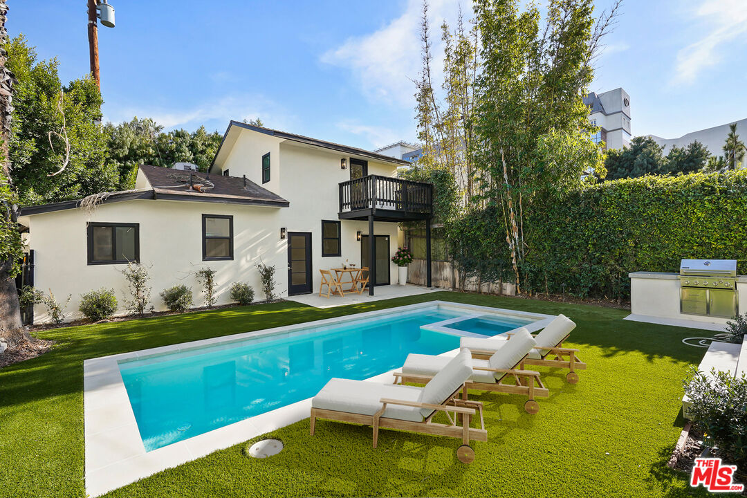 318 Huntley Drive West Hollywood, CA 90048 - Photo 14 of 25 a view of a house with a yard patio and swimming pool