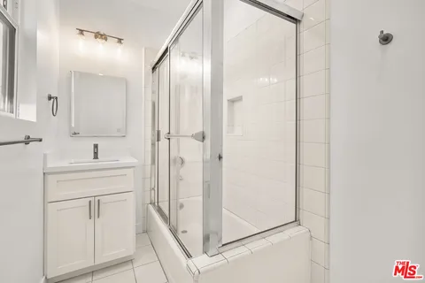 a bathroom with a shower and a sink
