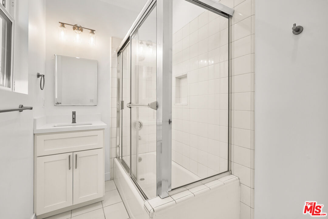 318 Huntley Drive West Hollywood, CA 90048 - Photo 23 of 25 a bathroom with a shower and a sink