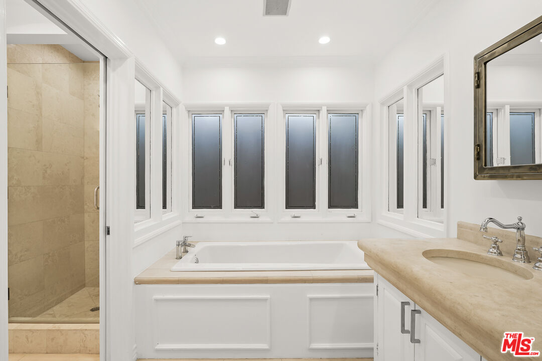 318 Huntley Drive West Hollywood, CA 90048 - Photo 10 of 25 a bathroom with a sink and a mirror