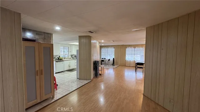 a view of a hallway with dining room and furniture