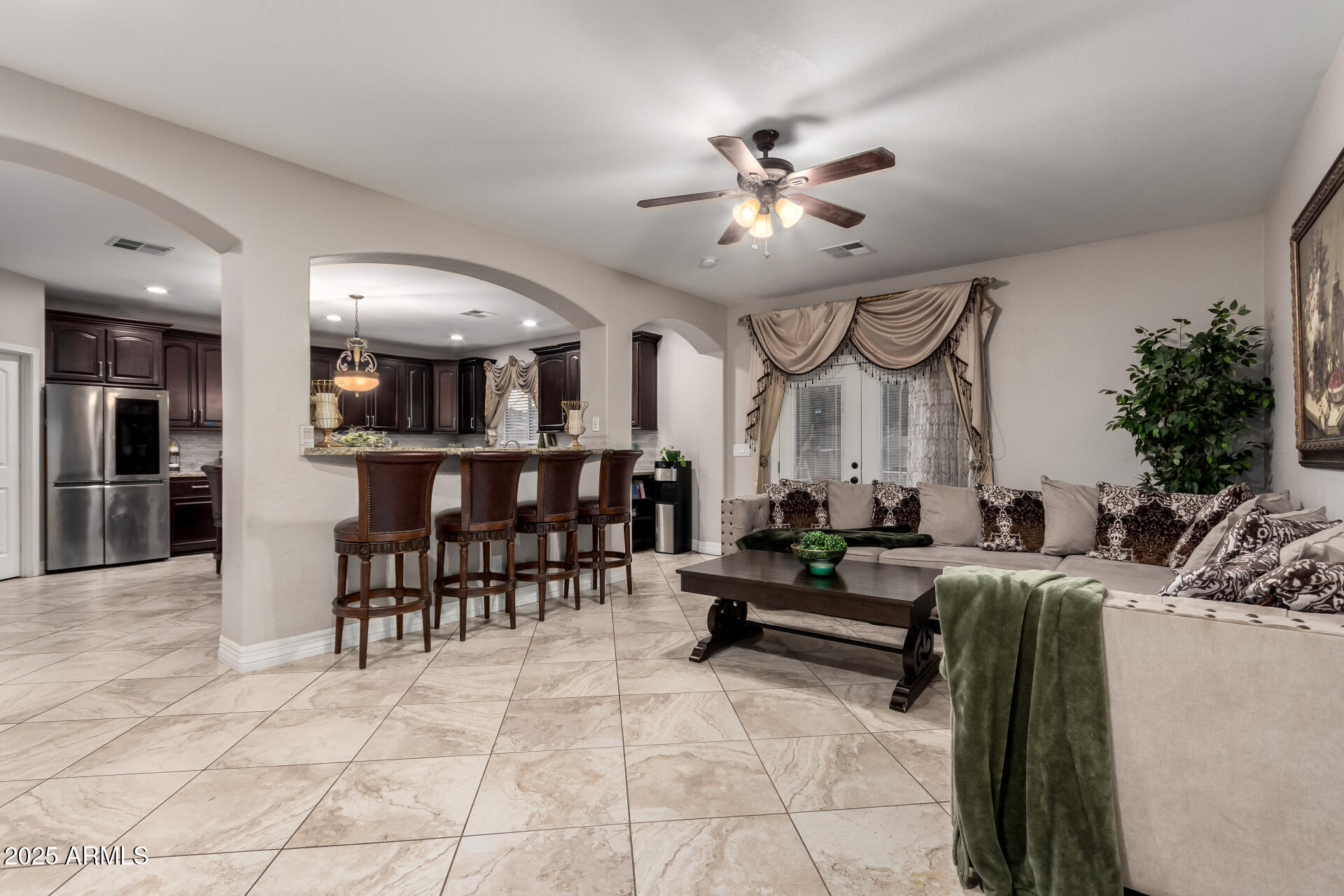 6344 West Lamar Road Glendale, AZ 85301 - Photo 13 of 37 a living room with furniture a dining table and a chandelier