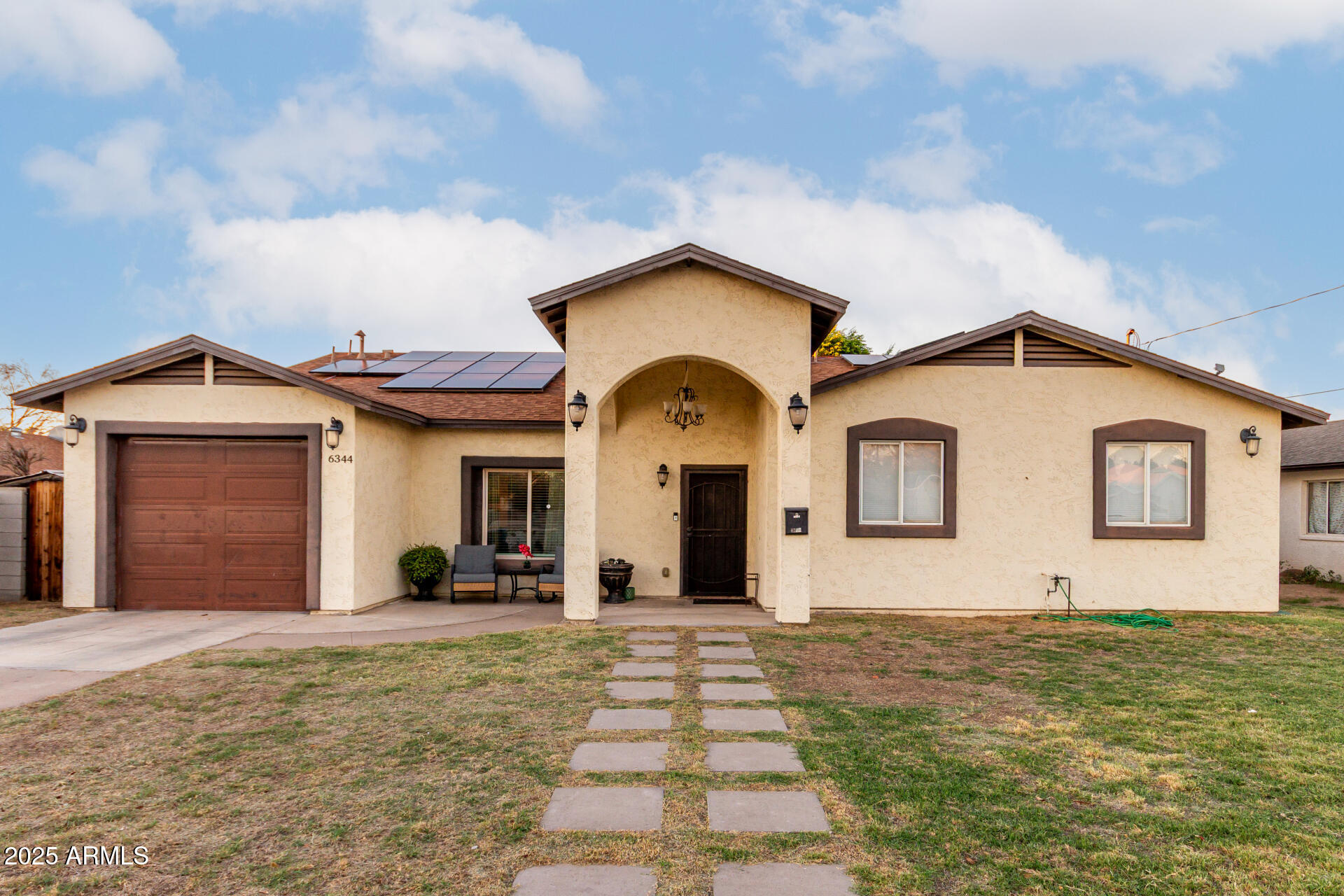 6344 West Lamar Road Glendale, AZ 85301 - Photo 2 of 37 a front view of a house with garden