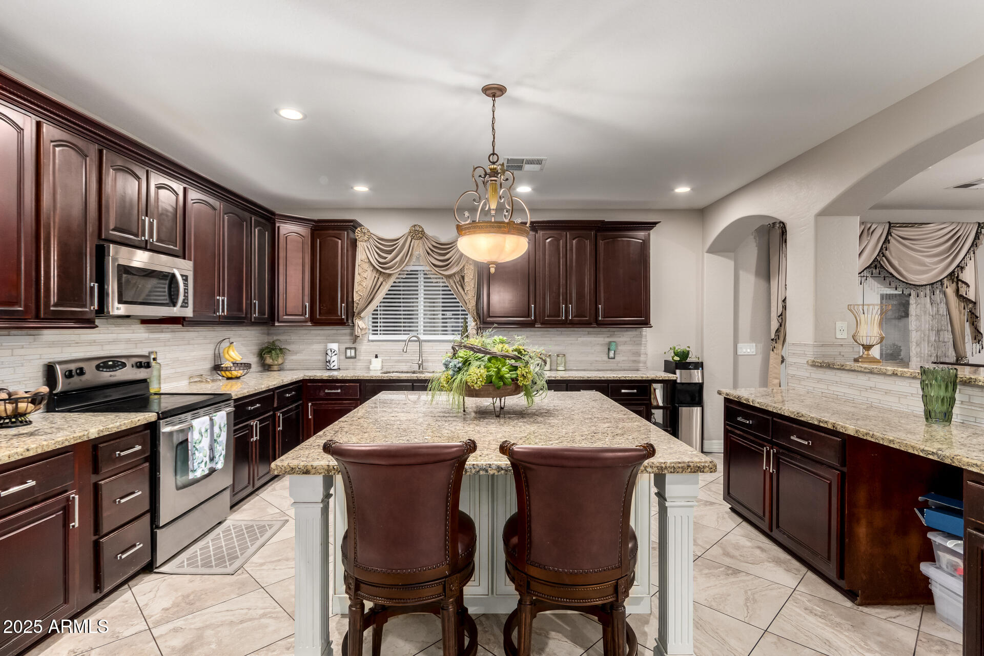 6344 West Lamar Road Glendale, AZ 85301 - Photo 22 of 37 a kitchen with granite countertop wooden cabinets and stainless steel appliances