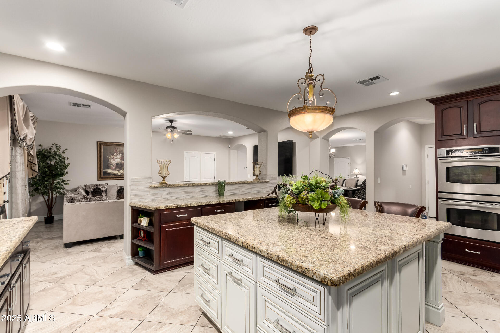 6344 West Lamar Road Glendale, AZ 85301 - Photo 23 of 37 a kitchen with granite countertop a center island and windows