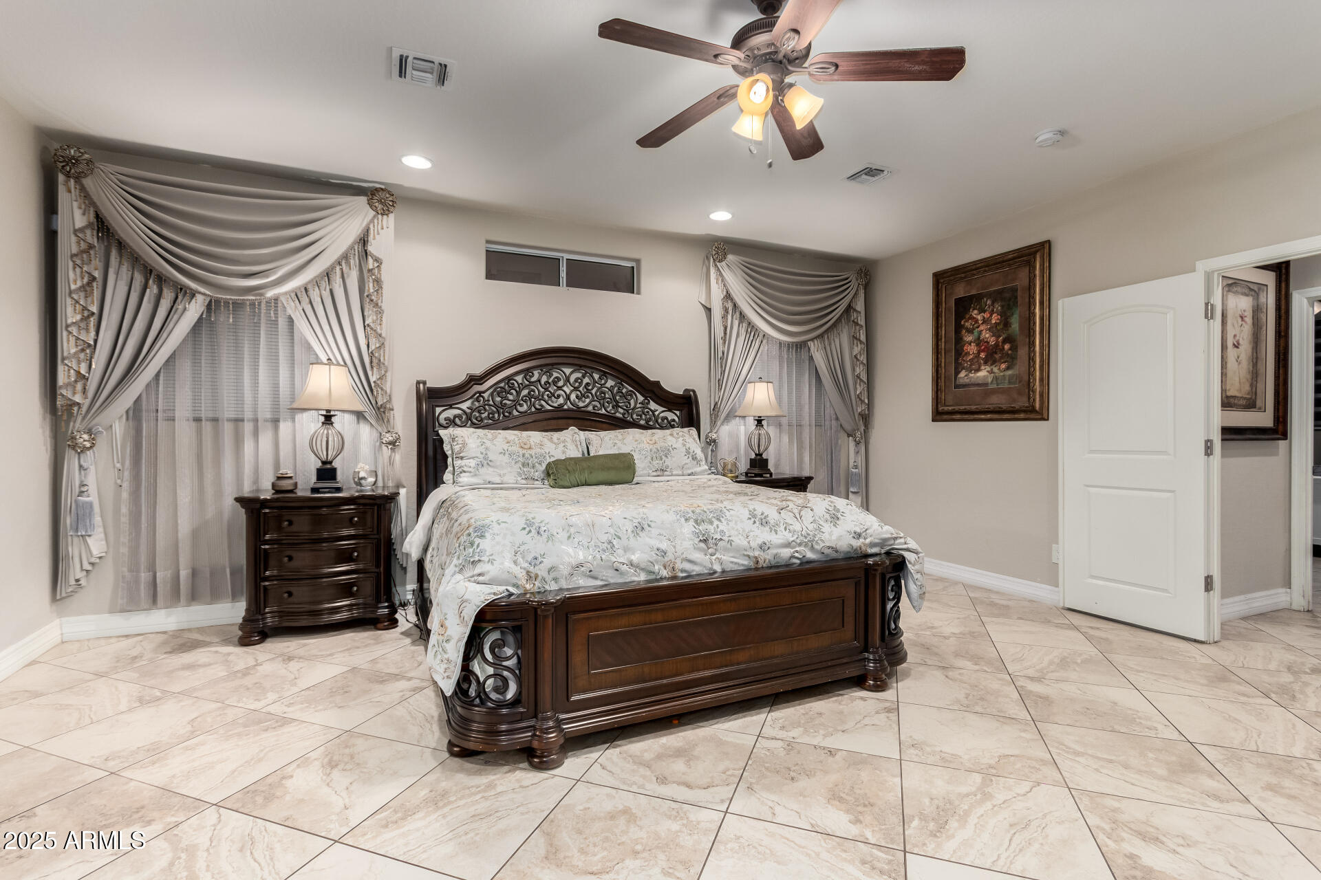 6344 West Lamar Road Glendale, AZ 85301 - Photo 25 of 37 a bedroom with a bed and a chandelier