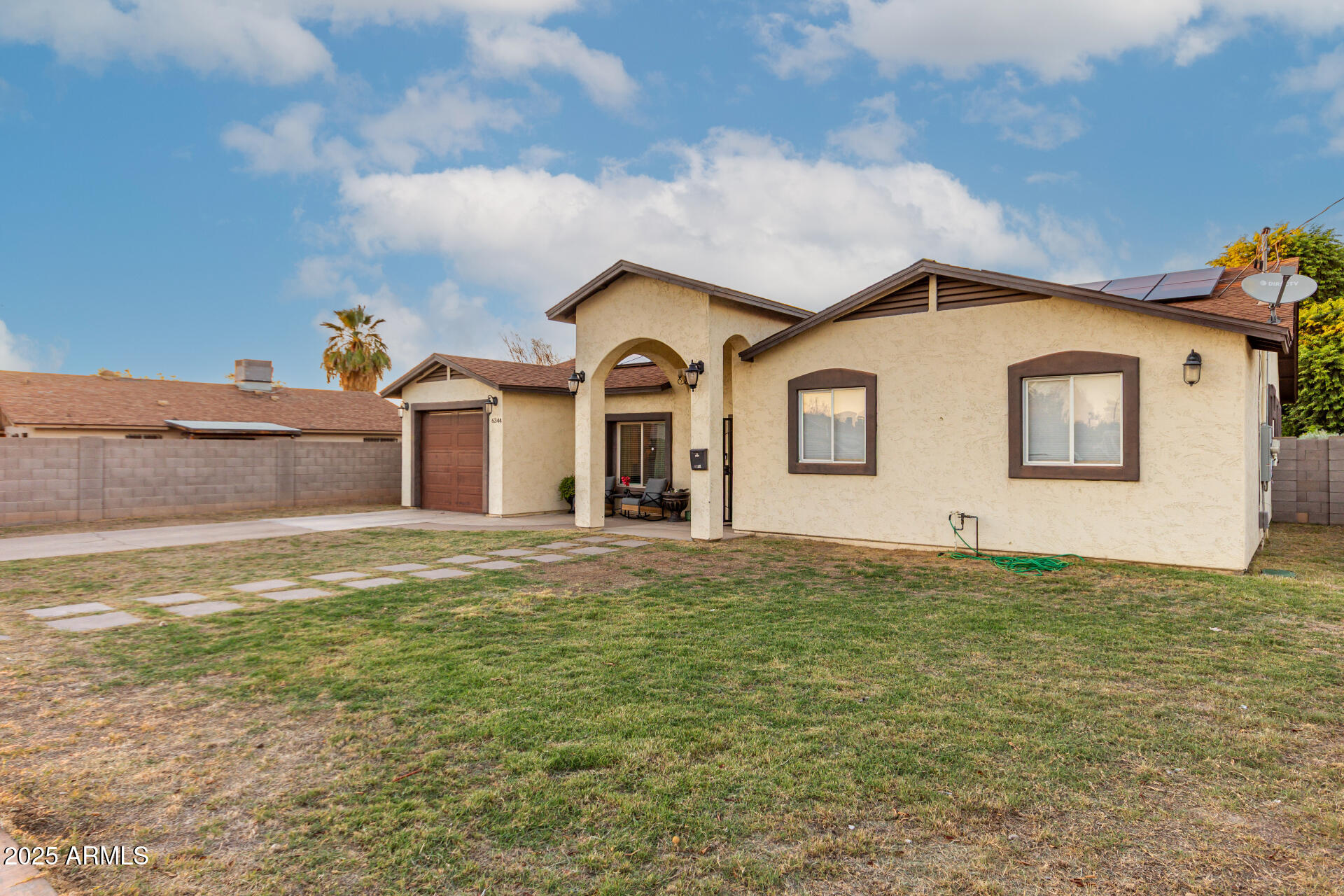 6344 West Lamar Road Glendale, AZ 85301 - Photo 3 of 37 a front view of a house with a garden