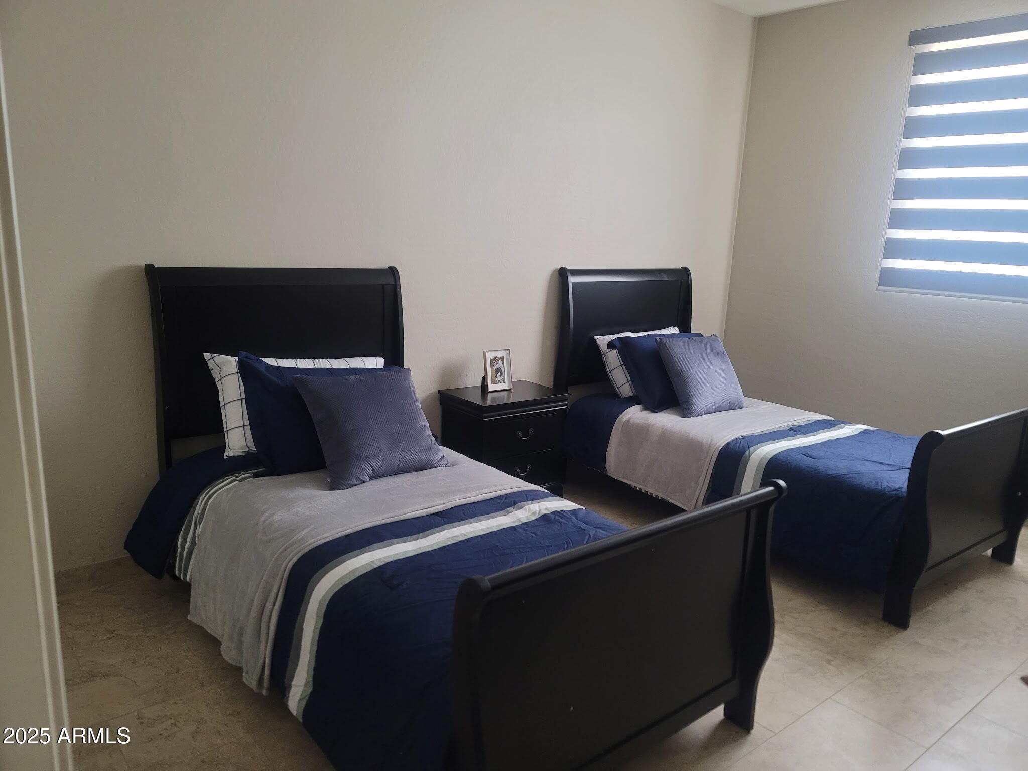 6344 West Lamar Road Glendale, AZ 85301 - Photo 33 of 37 a bedroom with two beds and a couch