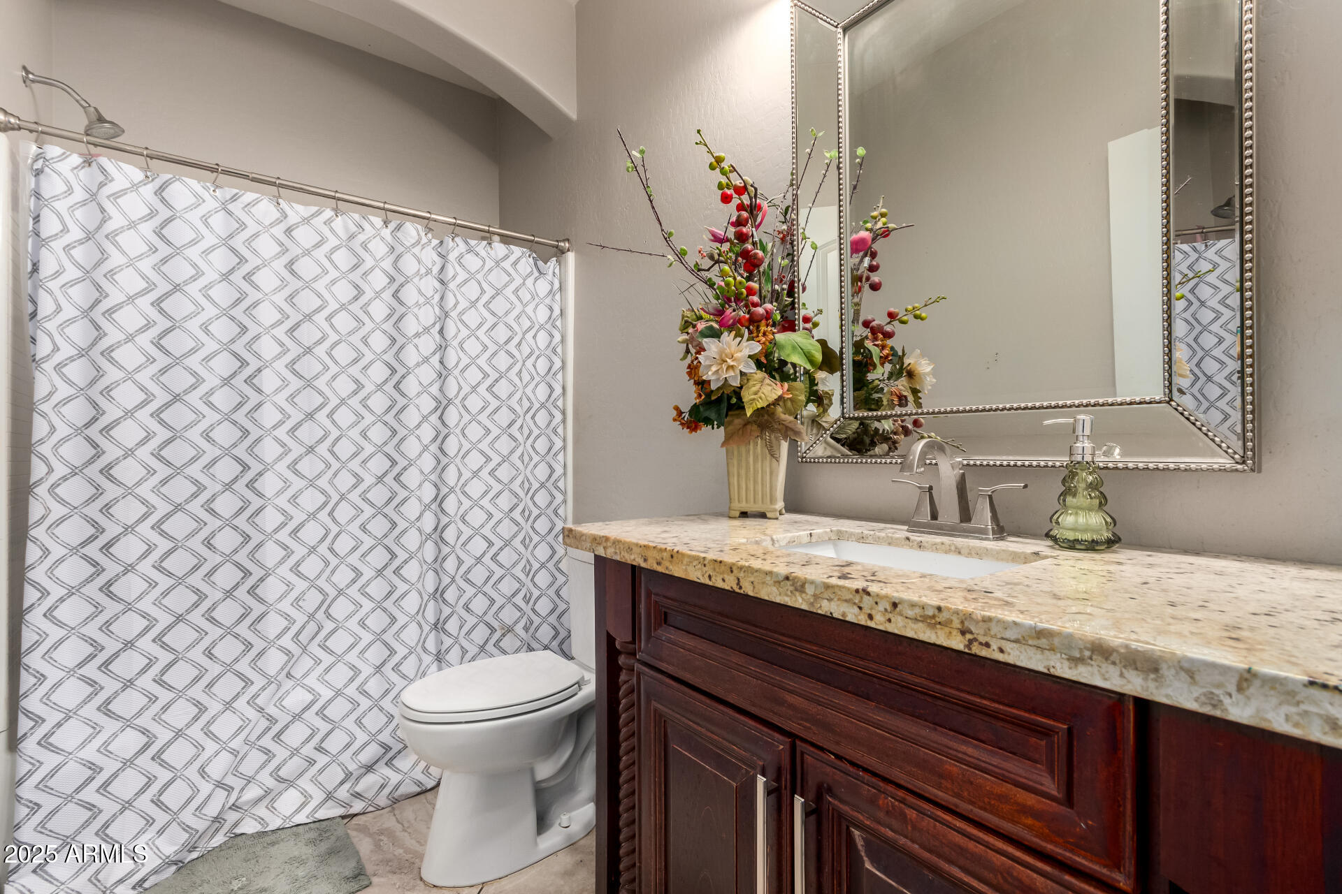 6344 West Lamar Road Glendale, AZ 85301 - Photo 36 of 37 a bathroom with a granite countertop toilet sink and mirror