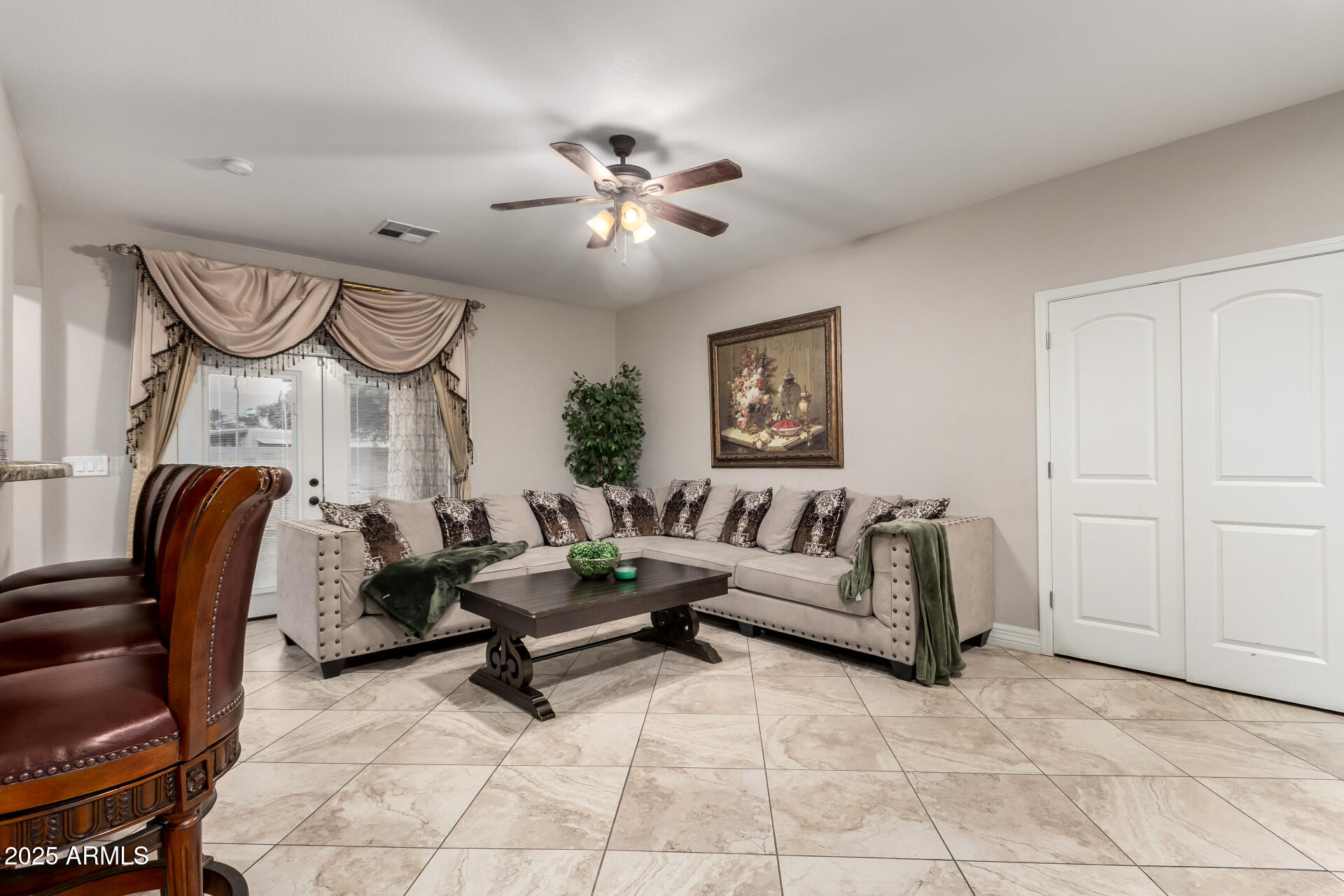 6344 West Lamar Road Glendale, AZ 85301 - Photo 10 of 37 a living room with furniture and a chandelier