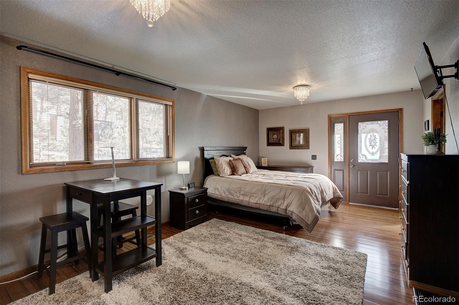 371 Hall Road Bailey, CO 80421 - Photo 18 of 40 a bed room with a bed and a window