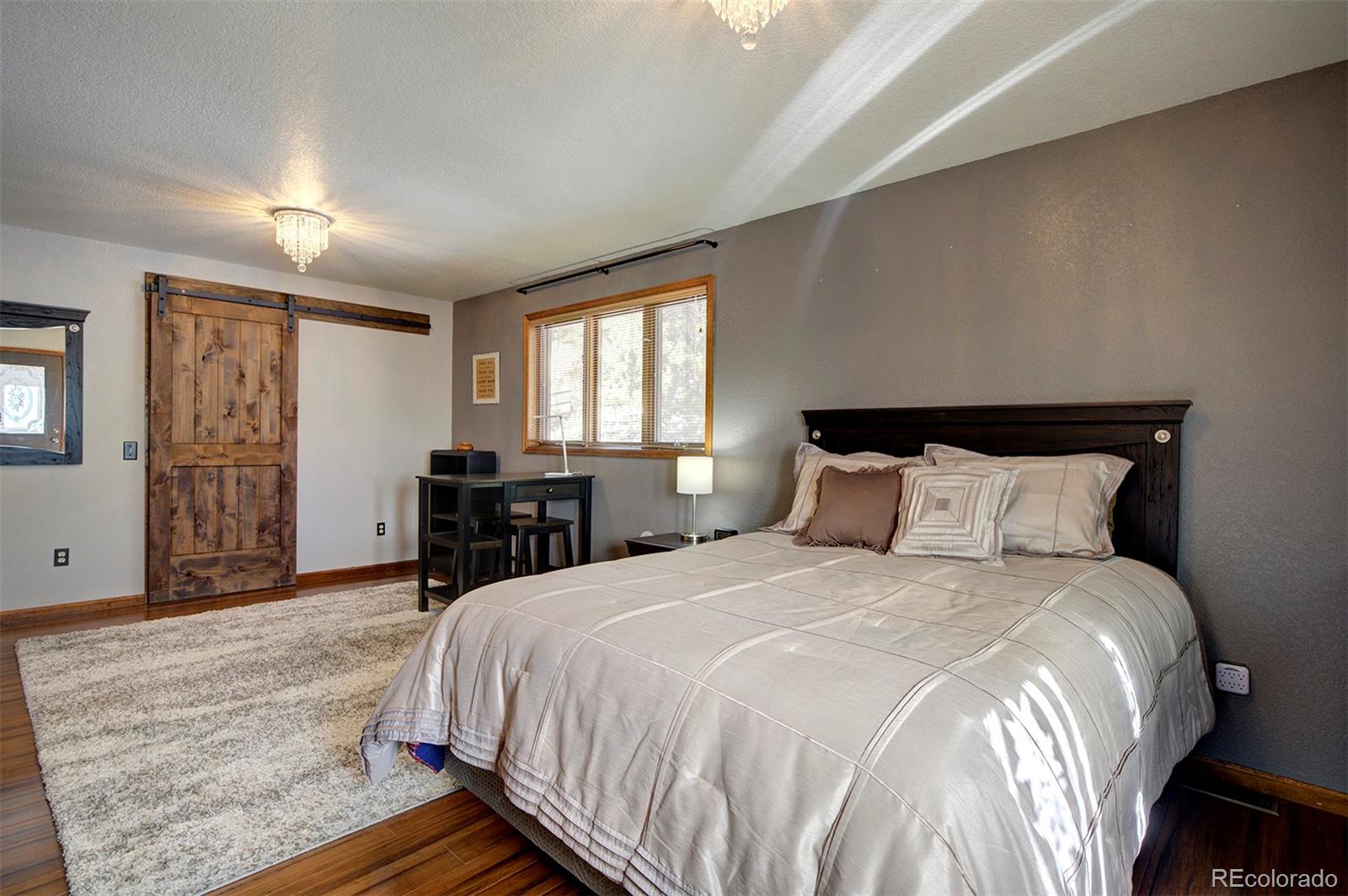 371 Hall Road Bailey, CO 80421 - Photo 20 of 40 a bedroom with a bed and a television