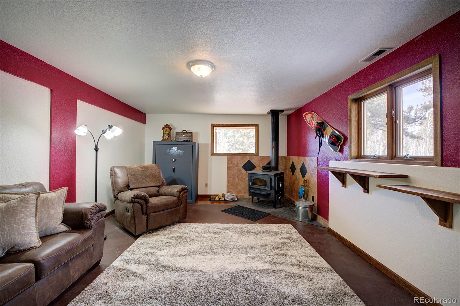 371 Hall Road Bailey, CO 80421 - Photo 28 of 40 a living room with furniture and a flat screen tv