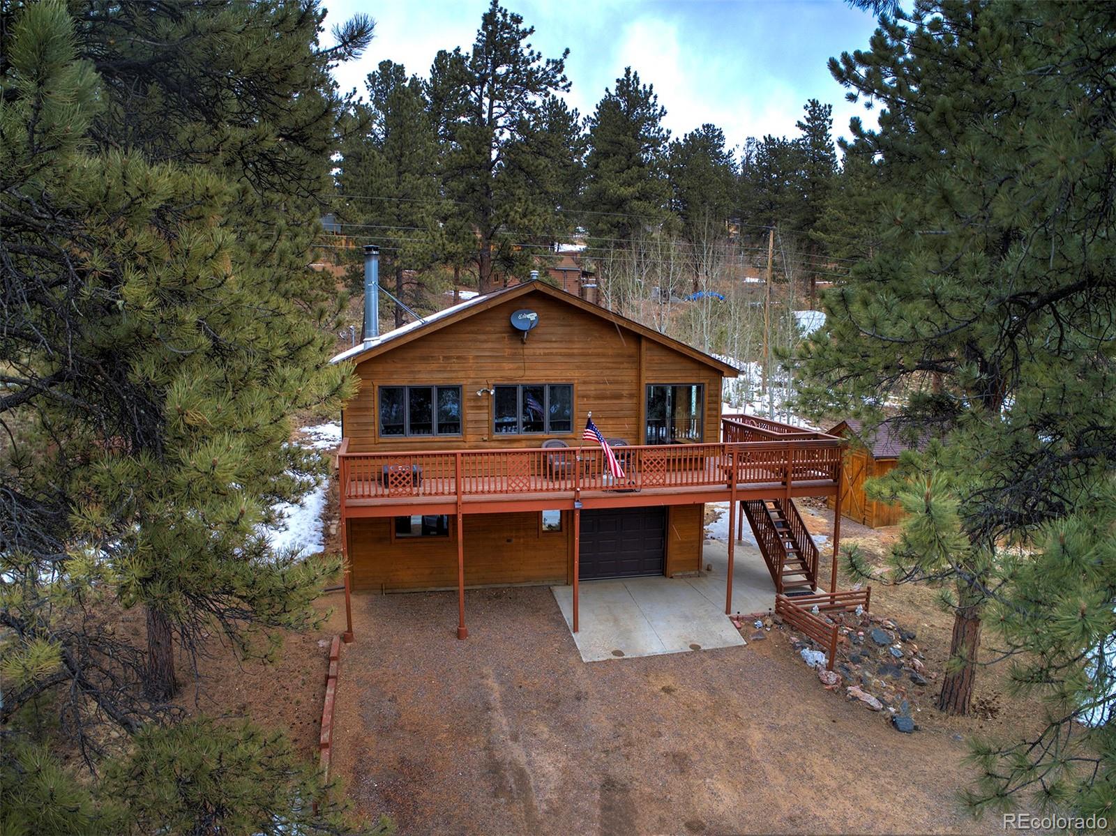 371 Hall Road Bailey, CO 80421 - Photo 3 of 40 a backyard of a house with table and chairs