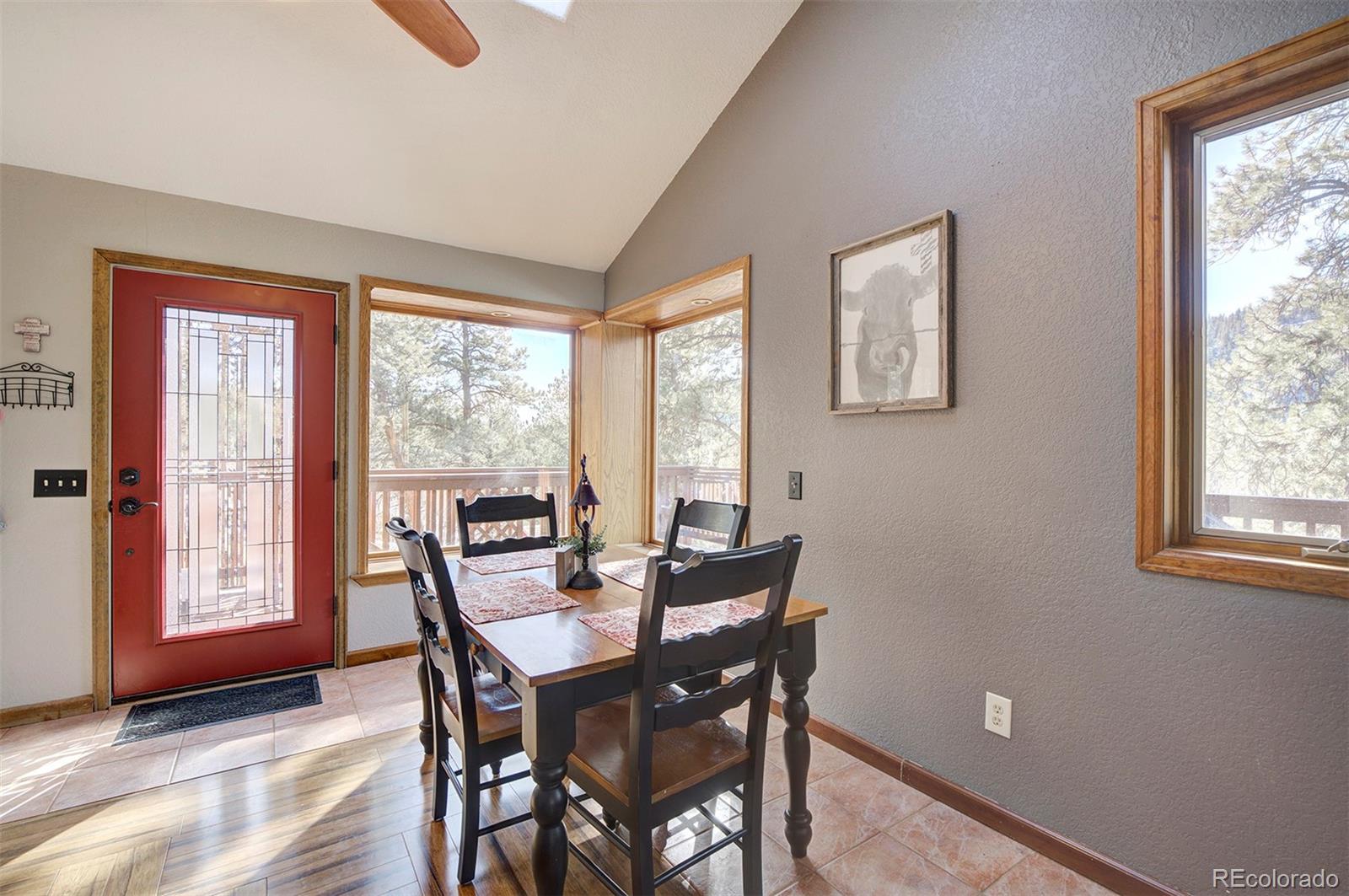 371 Hall Road Bailey, CO 80421 - Photo 7 of 40 a view of a dining room with furniture and windows