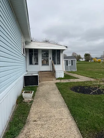 a front view of a house with a garden and yard