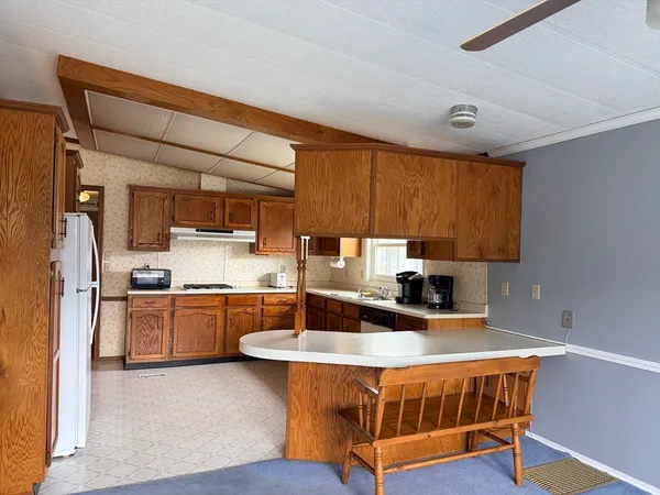 a kitchen with stainless steel appliances granite countertop a sink a stove and refrigerator