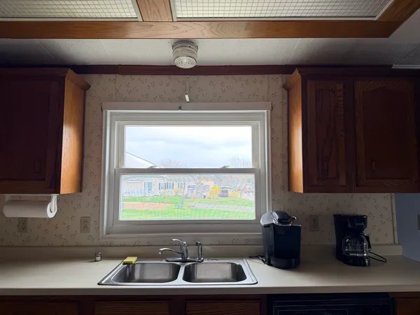a view of two windows and a sink