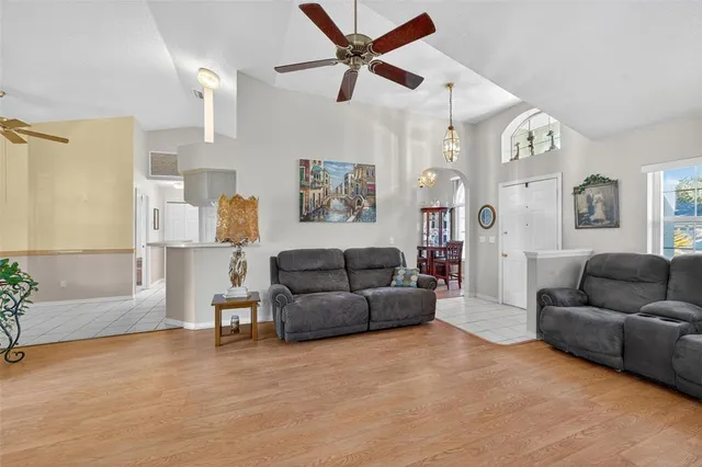 a living room with furniture and a chandelier