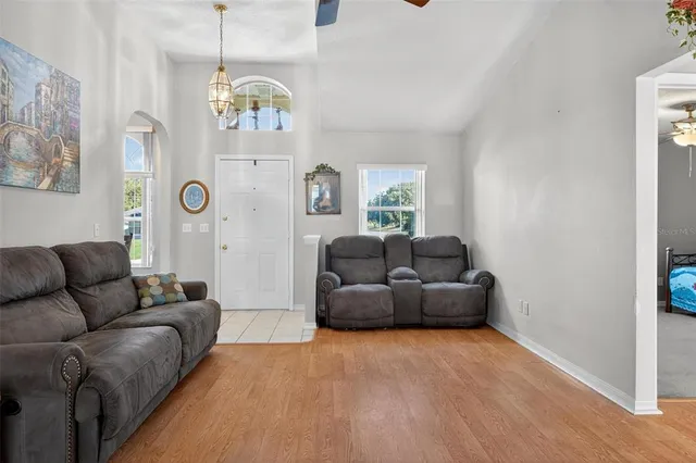 a kitchen with granite countertop a refrigerator and a stove top oven