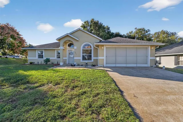 a front view of a house with a yard and outdoor seating