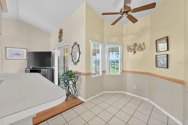 a living room filled with furniture and a large window