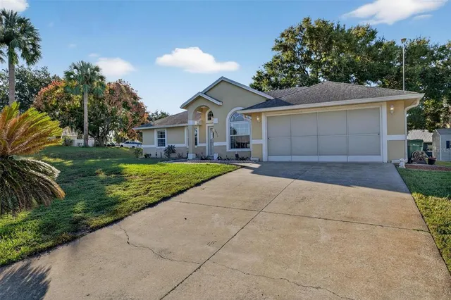 a front view of house with yard and green space