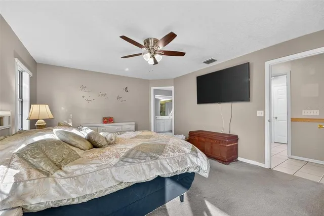 a bathroom with a granite countertop sink mirror vanity and toilet