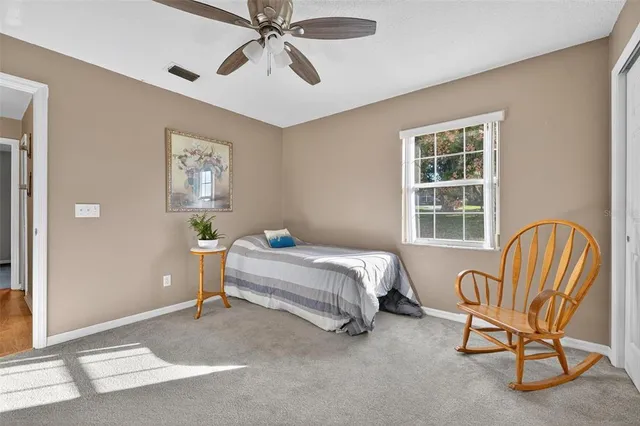 a front view of house with yard and trees in the background