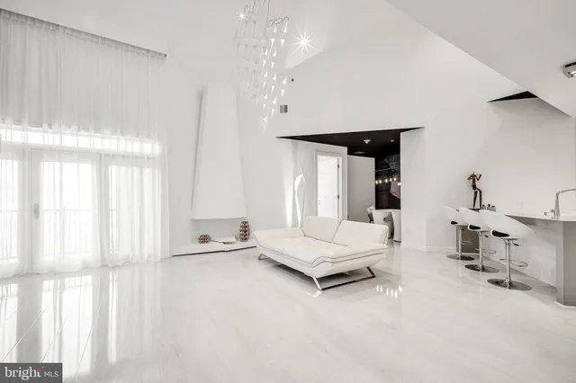 a living room with furniture and a chandelier