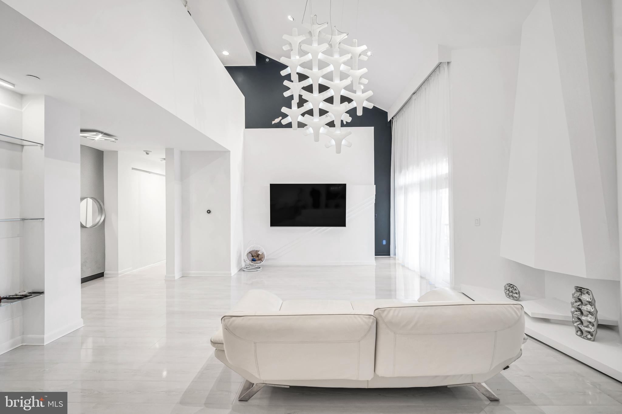 554 Carson Terrace Huntingdon Valley, PA 19006 - Photo 15 of 39 a living room with furniture a fireplace and a flat screen tv