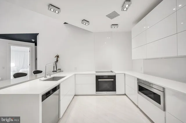 a kitchen with sink a stove and oven