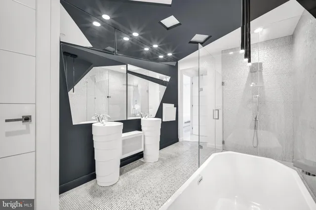 a spacious bathroom with a tub shower and sink