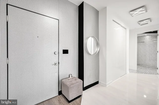 a view of a livingroom with bathroom and mirror