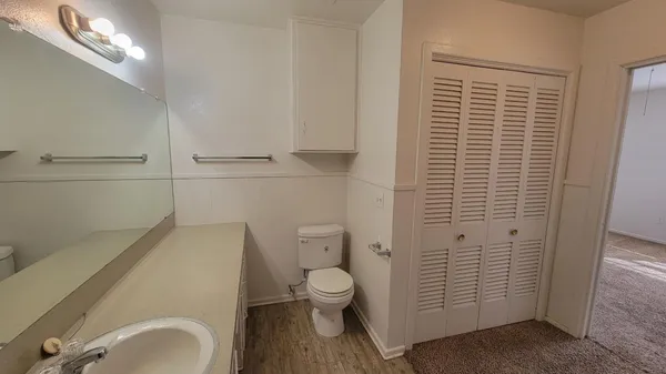 a bathroom with a granite countertop sink toilet and shower